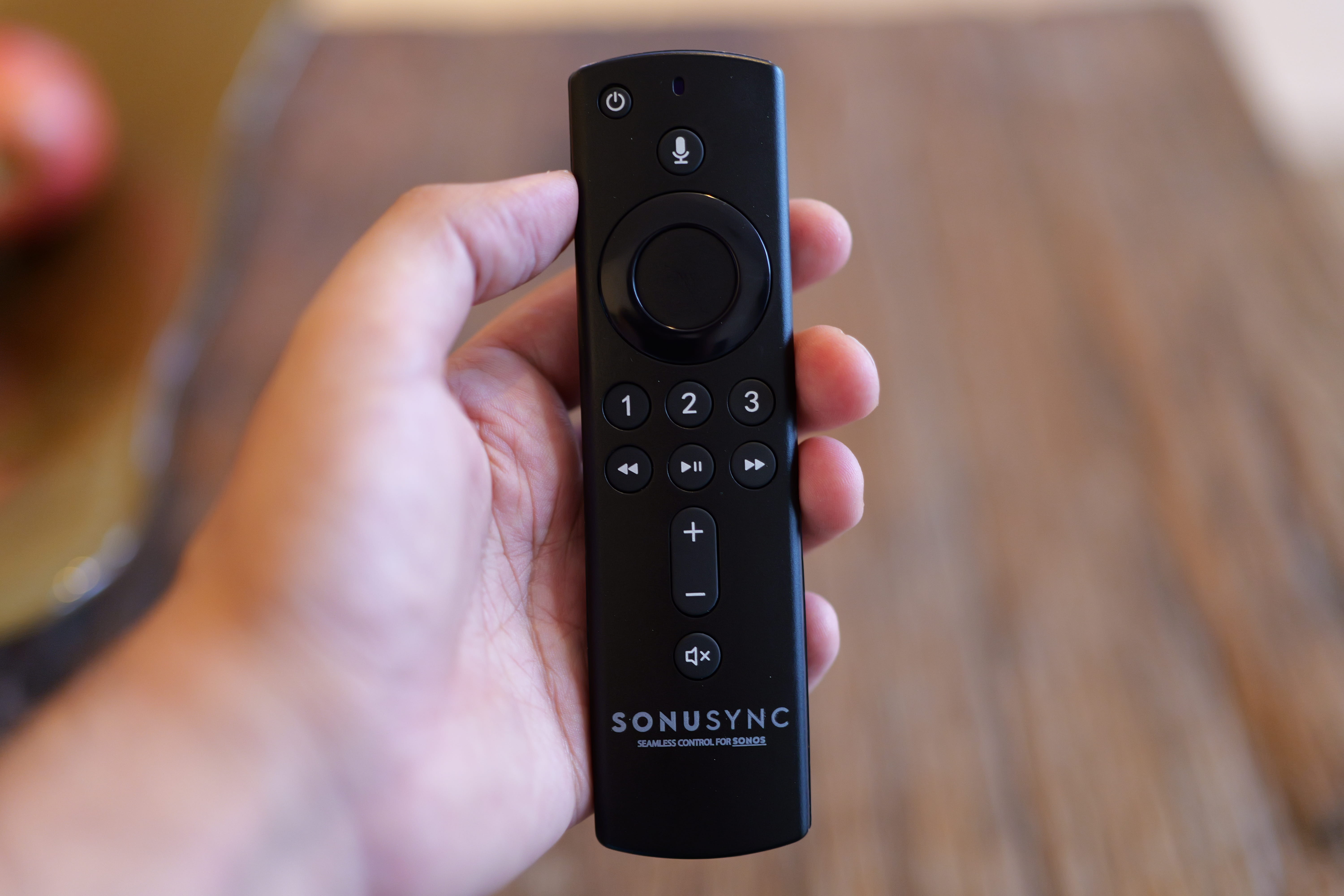 Hand holding SONUSYNC remote control